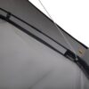 Close-up of a gray tent wall with black guy lines, a silver rope, and a mesh pocket detailing.